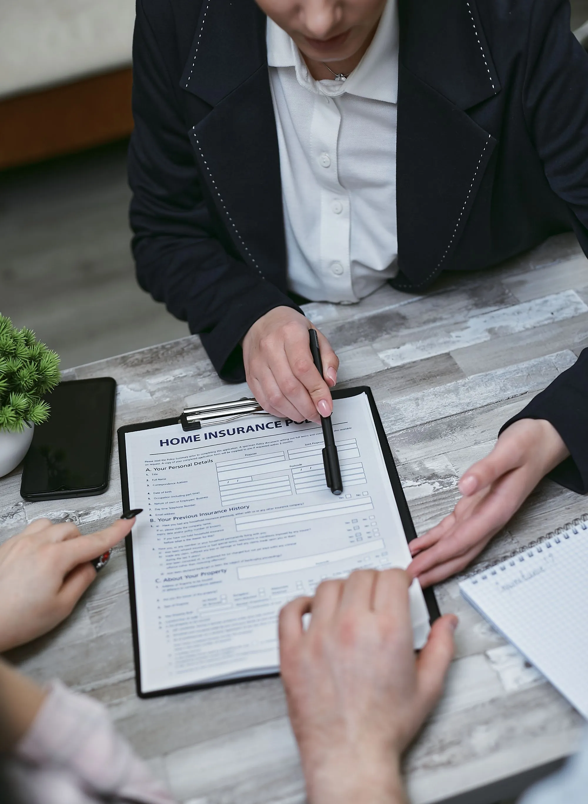 Insurance agent going over paperwork with clients